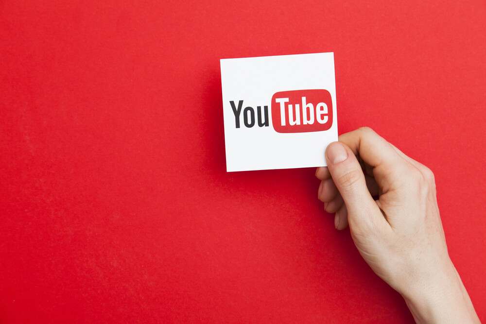 YouTube logo holding hand red background